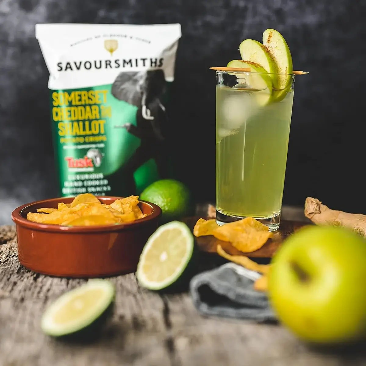 Savoursmiths  - Somerset Cheddar and Shallot Luxury Potato Crisps next to an apple cocktail